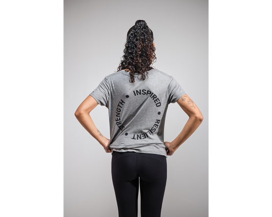 Person wearing a gray t-shirt with text on the back against a gray background