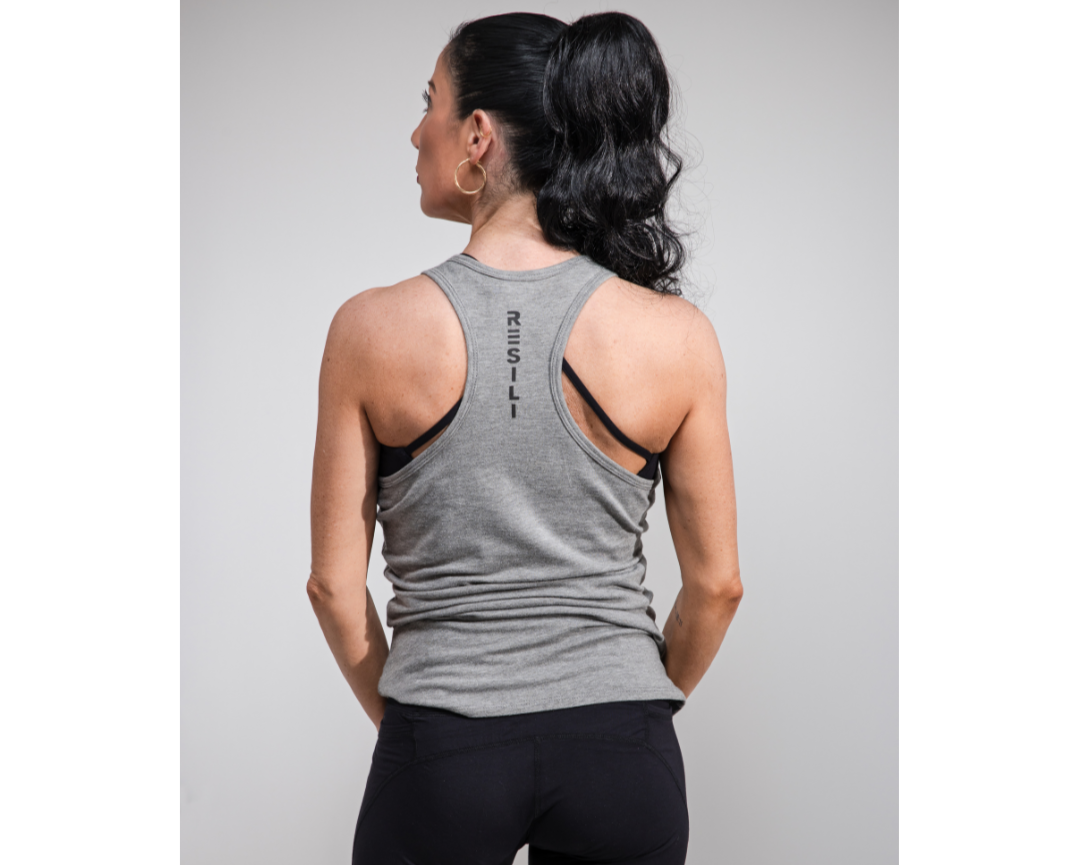 Woman wearing a gray tank top with 'Regali' branding on the back against a gray background