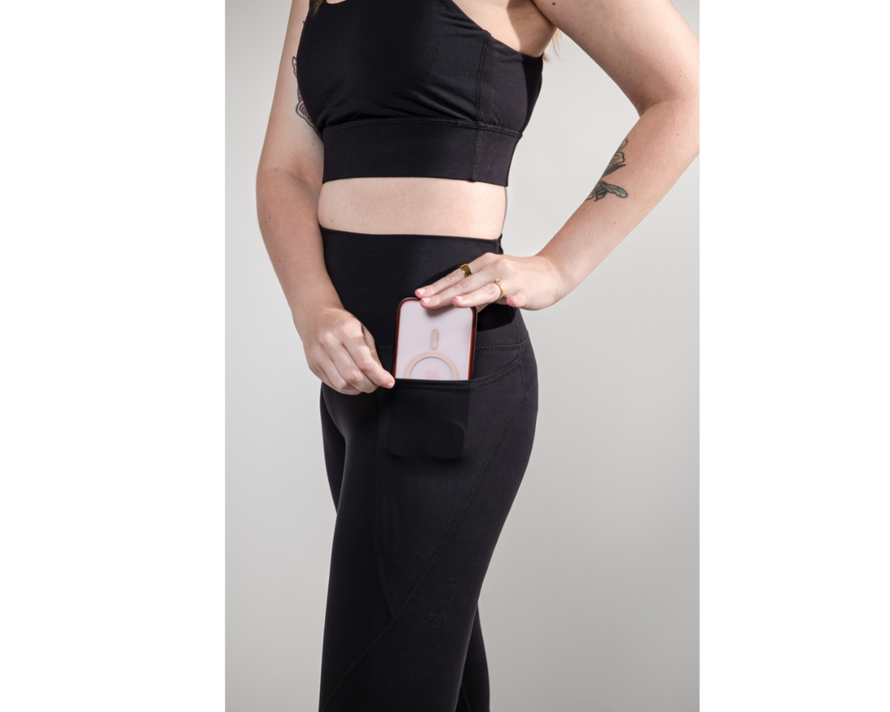 Person wearing black athletic wear with a gray background