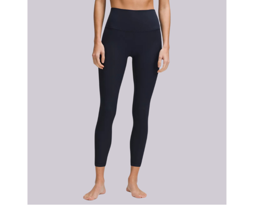 Person wearing black leggings on a plain background